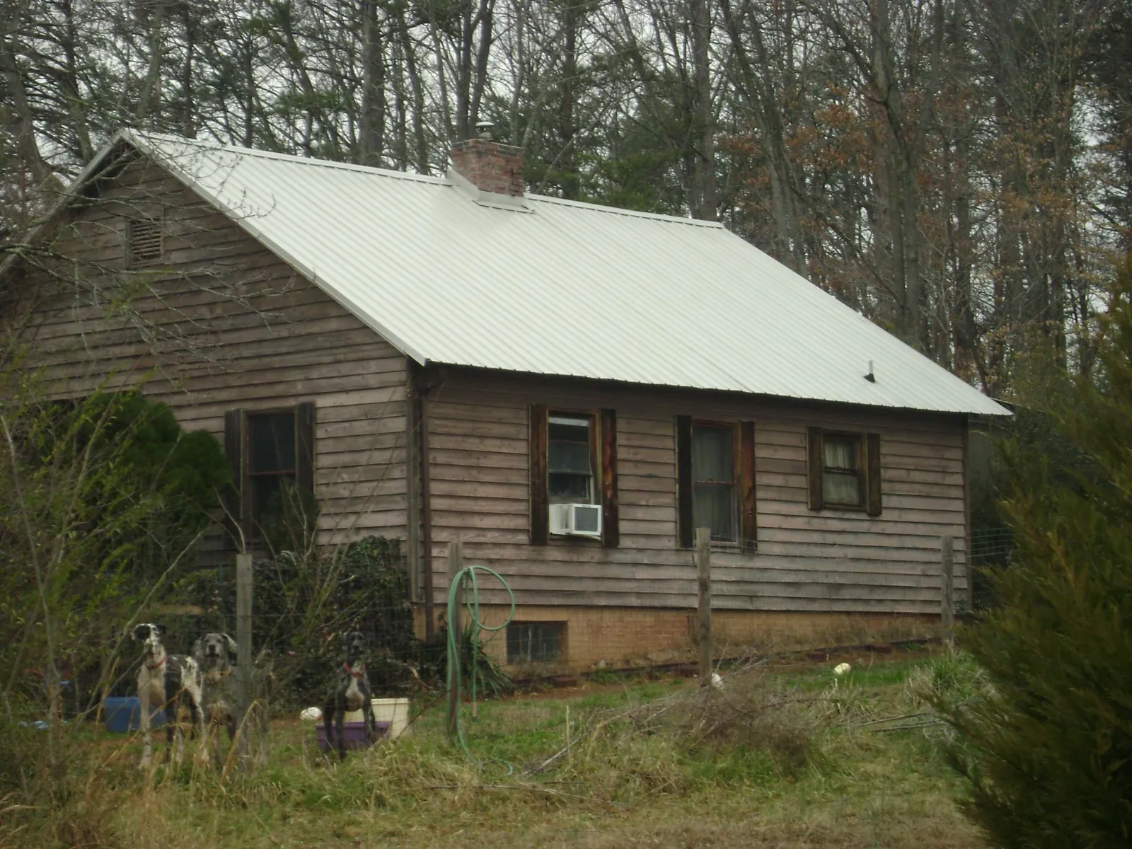 White metal roof on an old wood sided farmhouse, from a Metal Roof Installation job in Weare